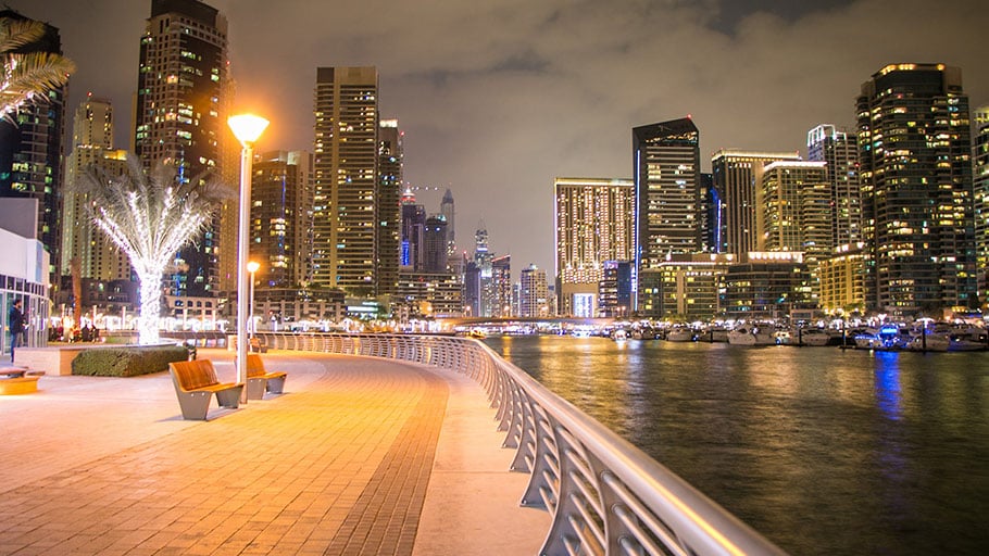 Urban pathway illuminated with streetlights at night.