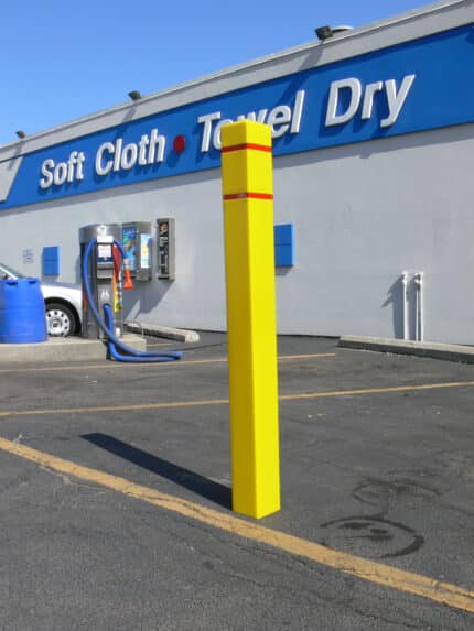 R-7140 plastic bollard cover in parking lot of car wash