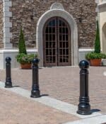 Three R-7551 decorative bollards adjacent to building