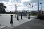 R-7563 decorative bollards in concrete with flags nearby