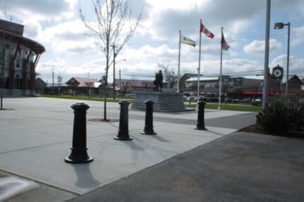 R-7563 decorative bollards in concrete with flags nearby