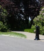 R-7563 decorative bollard in front of flower bush