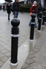 R-7571 decorative bollards on rainy city sidewalk
