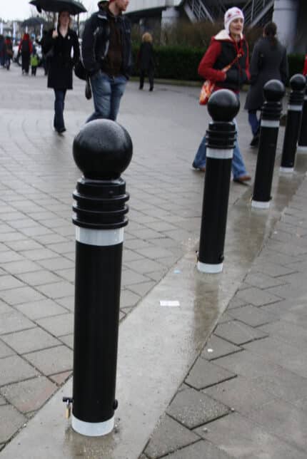 R-7571 decorative bollards on rainy city sidewalk