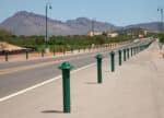 Rows of green R-7572 decorative bollards along highway