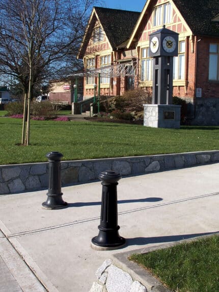 Two R-7581 decorative bollards guard driveway entrance