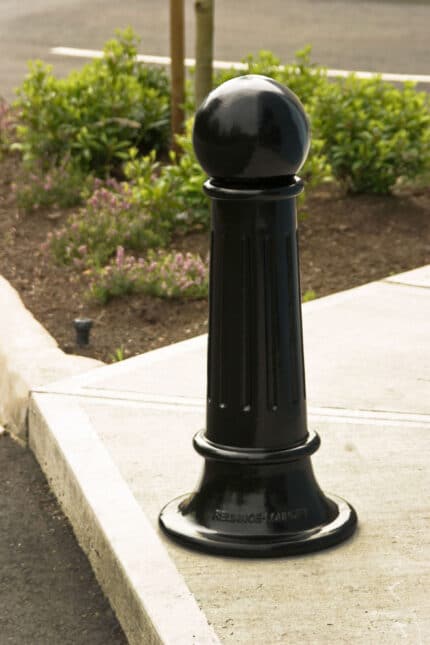 Single R-7582 decorative bollard on street corner