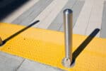 R-8902 stainless steel bollard on yellow speed hump