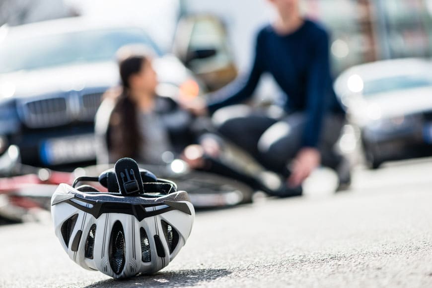 A helmet lies on the ground following a collision between a cyclist and a car