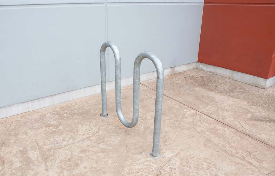 An industrial bike rack embedded in cement
