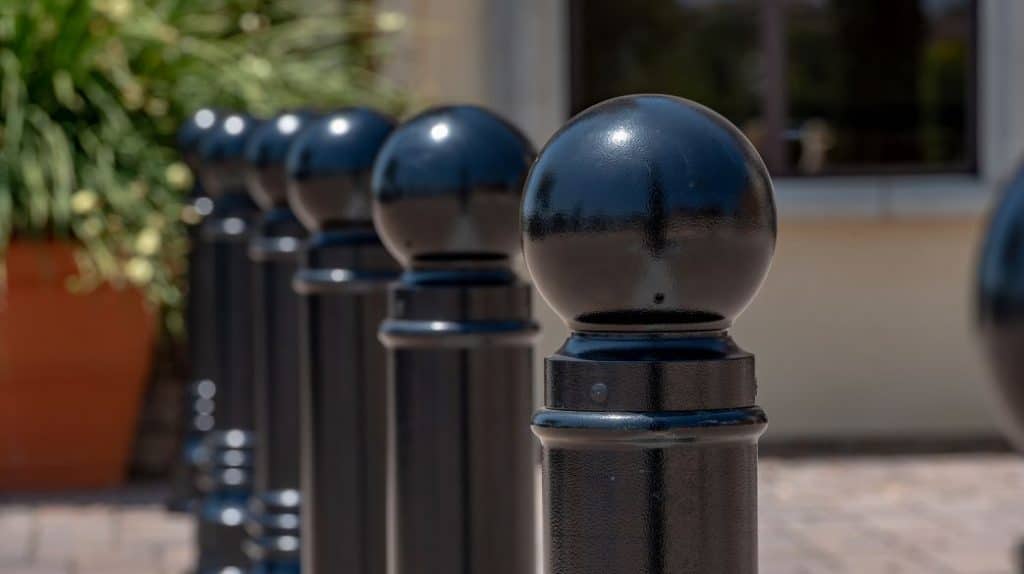 A series of black cast iron bollards created from a traditional pattern