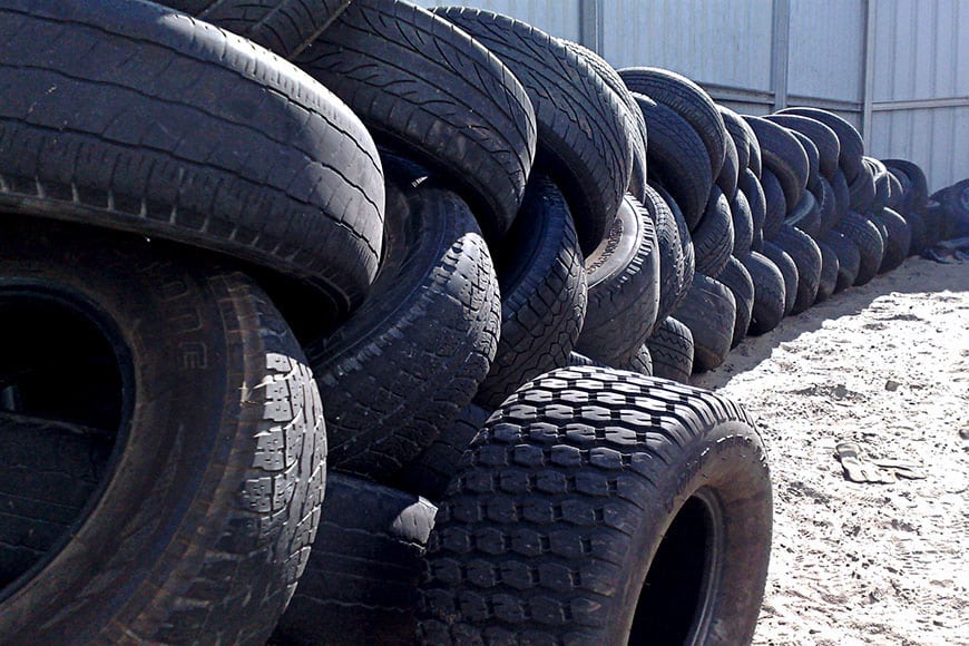 Pile of rubber tires at rubber recycling plant